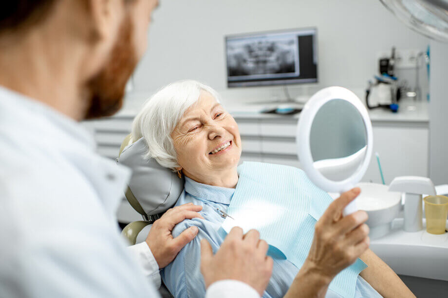 Old lady smiling looking at teeth image