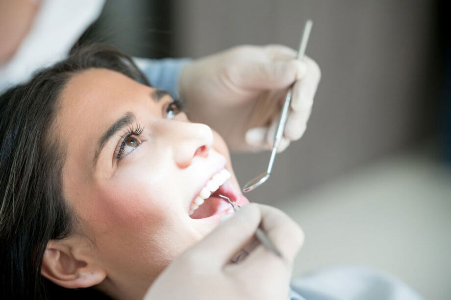 woman in dental chair having teeth examined